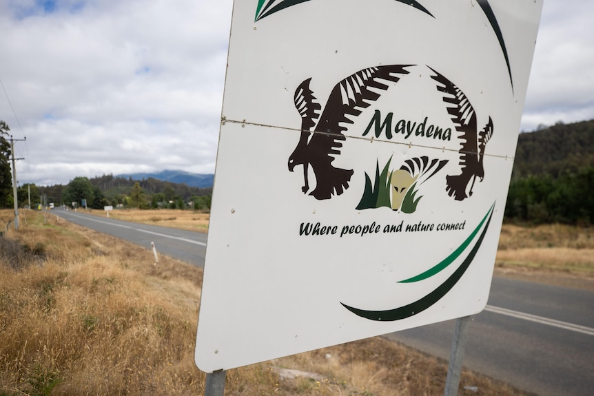 A town sign for Maydena on the side of a road.