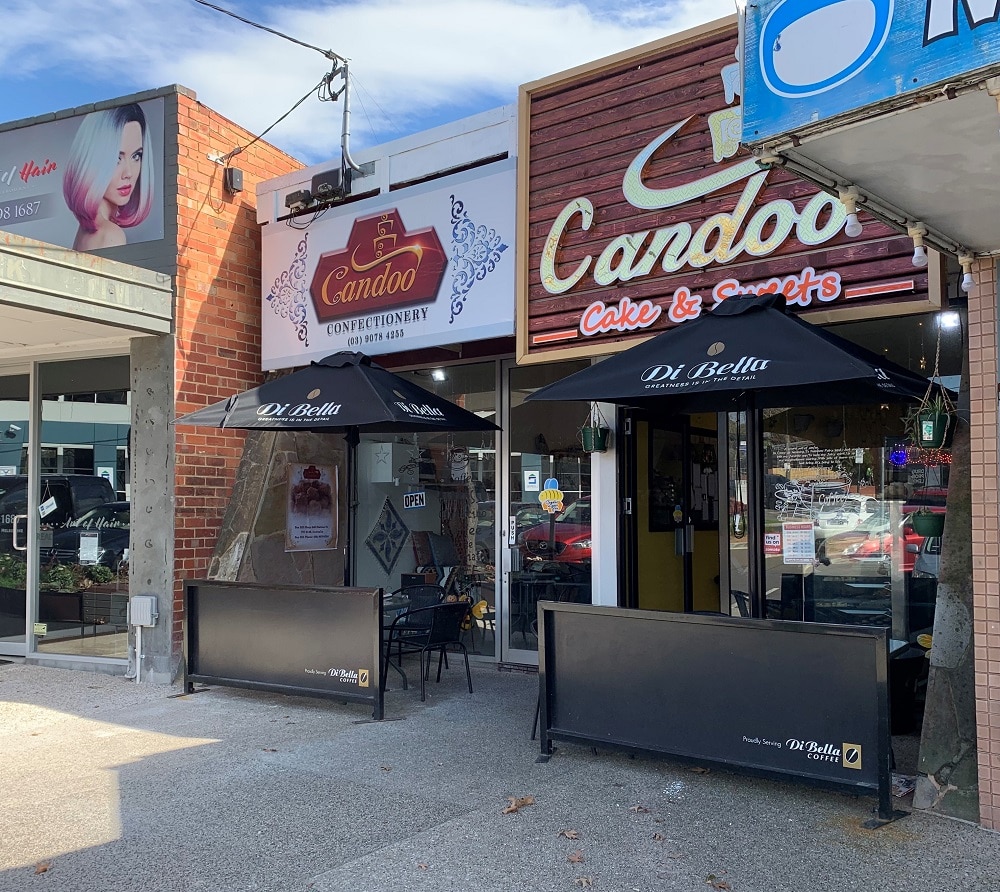 The Candoo Confectionery and Candoo Cake and Sweets shop fronts are side-by-side in a residential shopping strip.