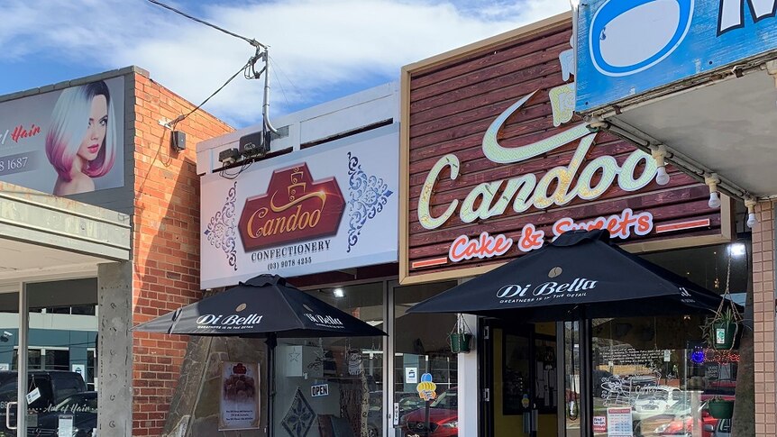 The Candoo Confectionery and Candoo Cake and Sweets shop fronts are side-by-side in a residential shopping strip.