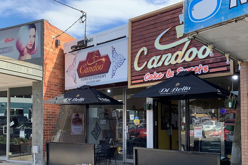 The Candoo Confectionery and Candoo Cake and Sweets shop fronts are side-by-side in a residential shopping strip.