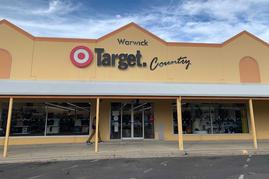 A man walks towards the front entrance of a Target Country store.