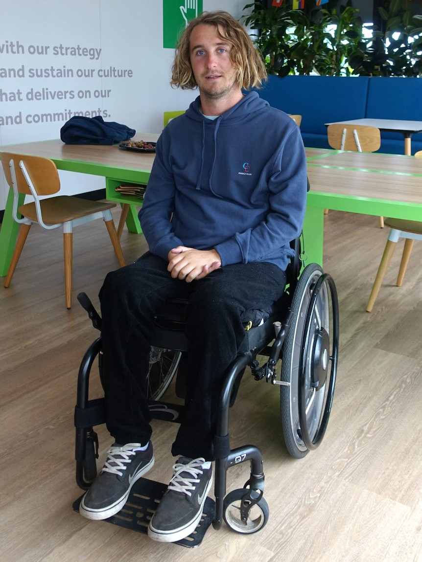 Jason Apps sits in a wheelchair.