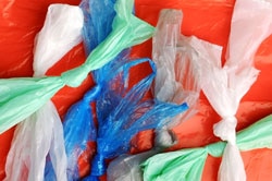 Different coloured plastic  bags with knots in them.