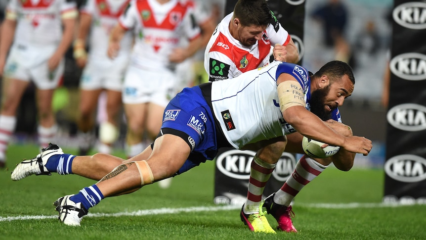 The Bulldogs' Sam Kasiano dives over for a try against the Dragons at the Olympic stadium.