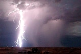 A bolt of lightning strikes the ground