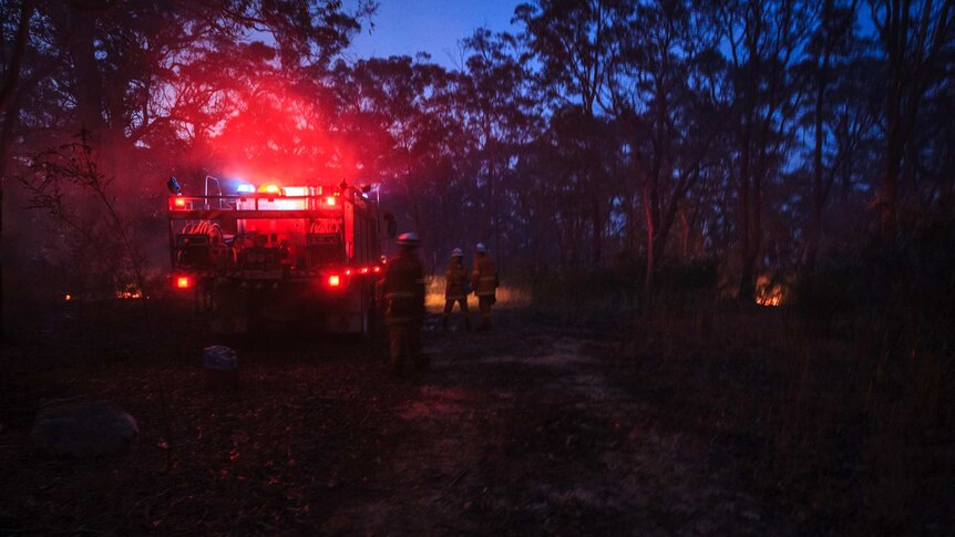Volunteers gather by an RFS truck during back-burning operations in the Blue Mountains (Photo: John Donegan)