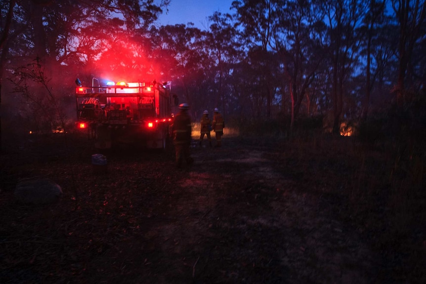 Volunteers gather by an RFS truck during back-burning operations in the Blue Mountains (Photo: John Donegan)