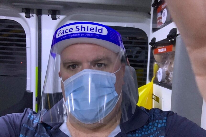 Hotel Grand Chancellor traveller in quarantine Paul Atta in PPE in an ambulance.