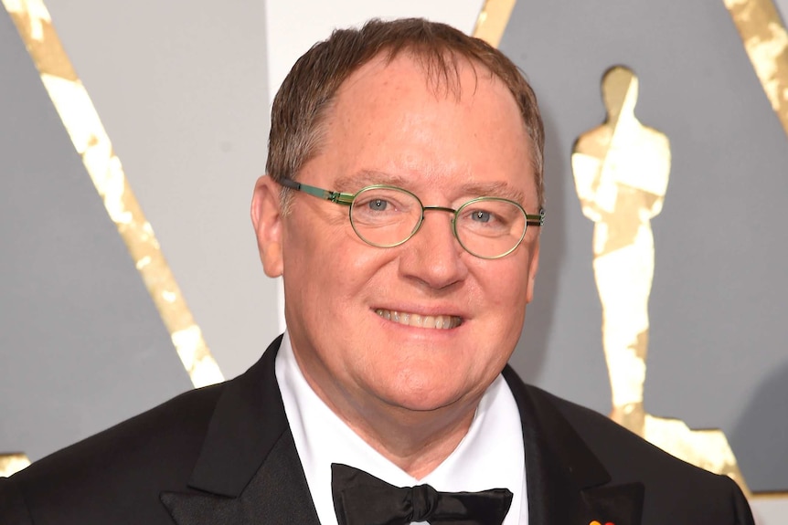 Close-up of Pixar co-founder John Lasseter in a black suit with a bow tie.