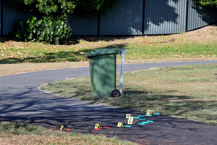 Blood splatter markers are seen at a police crime scene at Frascott Park