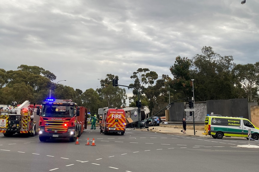 a crash scene at an intersection with emergency vehicles nearby