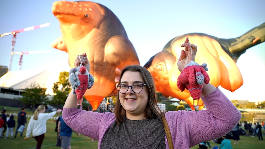 Skywhale fan Penny Camens stands in front of the balloons.