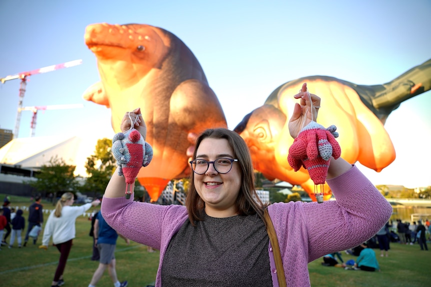 Skywhale fan Penny Camens stands in front of the balloons.