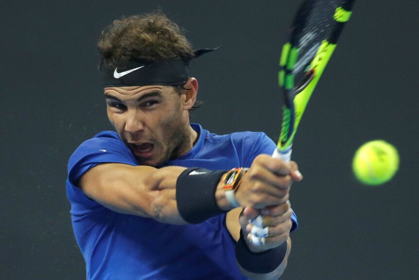 Close-up of Nadal playing double-handed backhand.