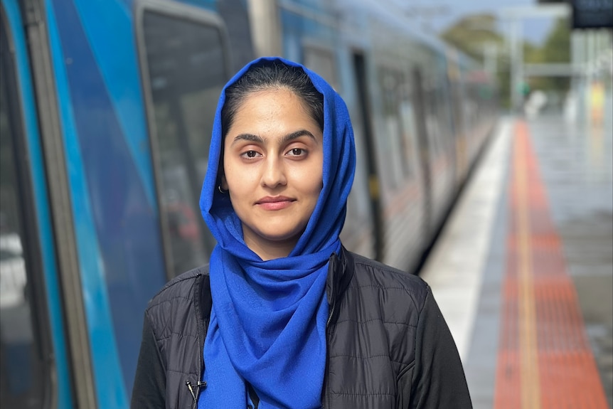 A woman in a hijab on a train platform