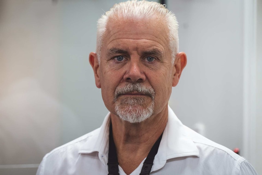 a man looking into the camera inside an office