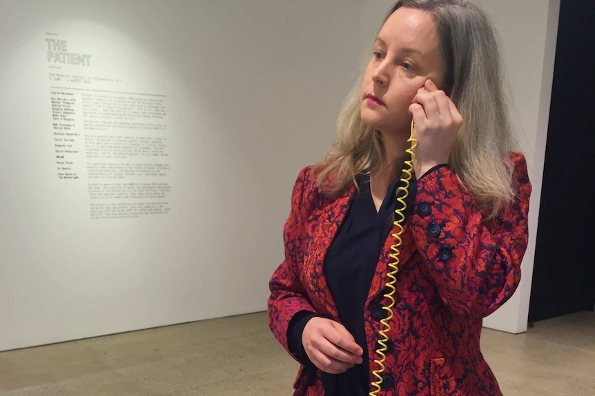 UNSW galleries curator Bec Dean trying out one of the interactive artworks in an exhibit