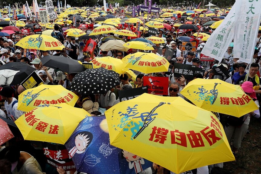 Demonstrators hold yellow umbrellas during a protest in Hong Kong.