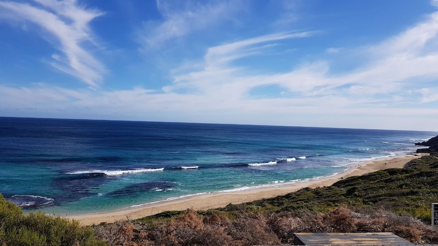 A shot of blue waters and cliffs on the coast.