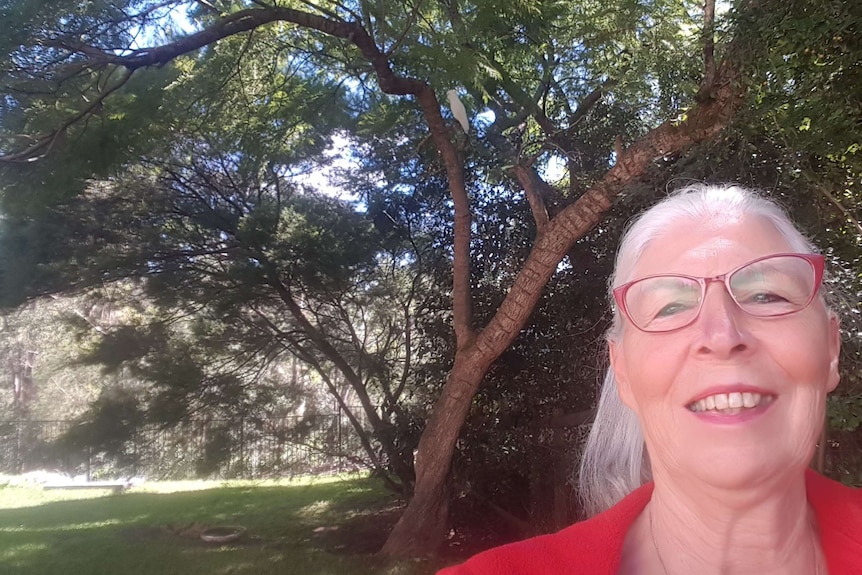 woman wearing glasses smiling and looking