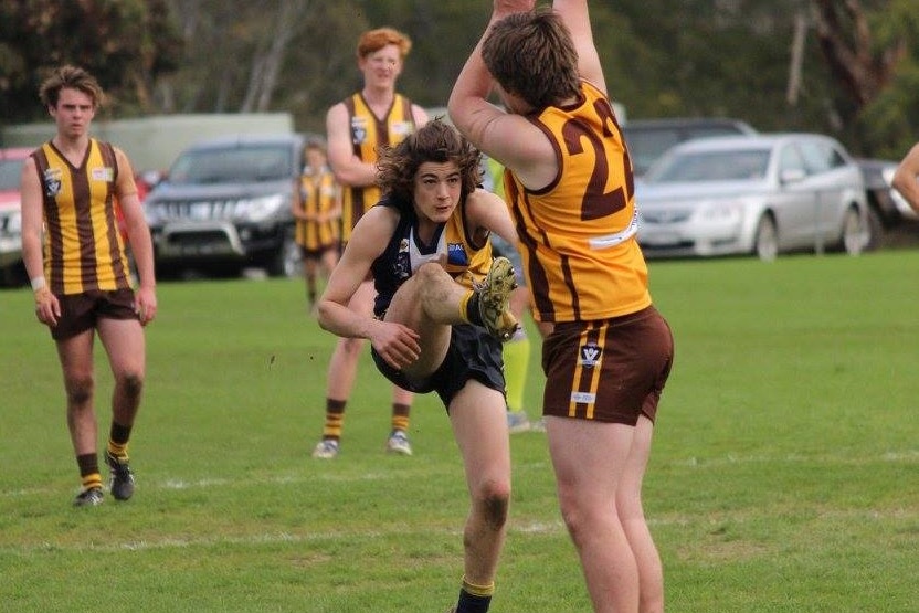 Sam Lambevski kicking a football for his junior club in south-west Victoria