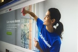A screenshot of a woman cleaning in an image from the Airtasker website.