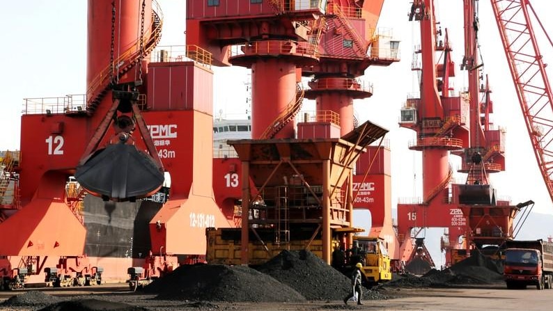  Cranes unload coal from a cargo ship at a port in Lianyungang, Jiangsu province, China