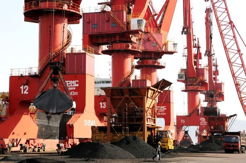  Cranes unload coal from a cargo ship at a port in Lianyungang, Jiangsu province, China