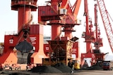  Cranes unload coal from a cargo ship at a port in Lianyungang, Jiangsu province, China