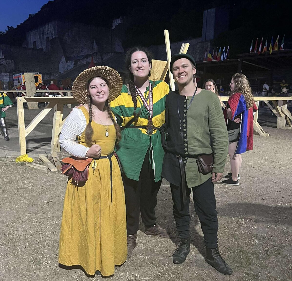 Three people wearing medieval costumes 