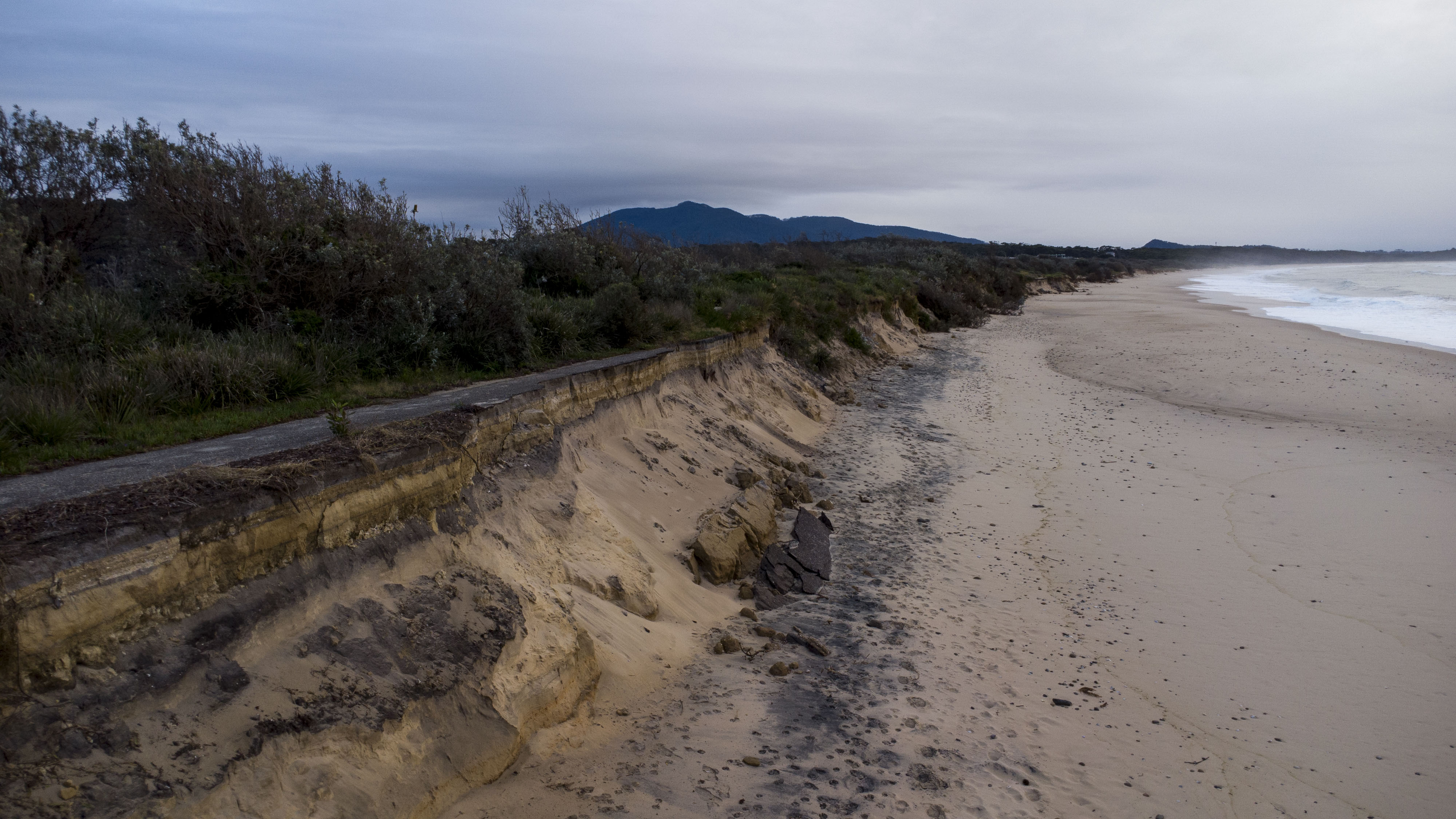 sand washed away from a bank with erosion