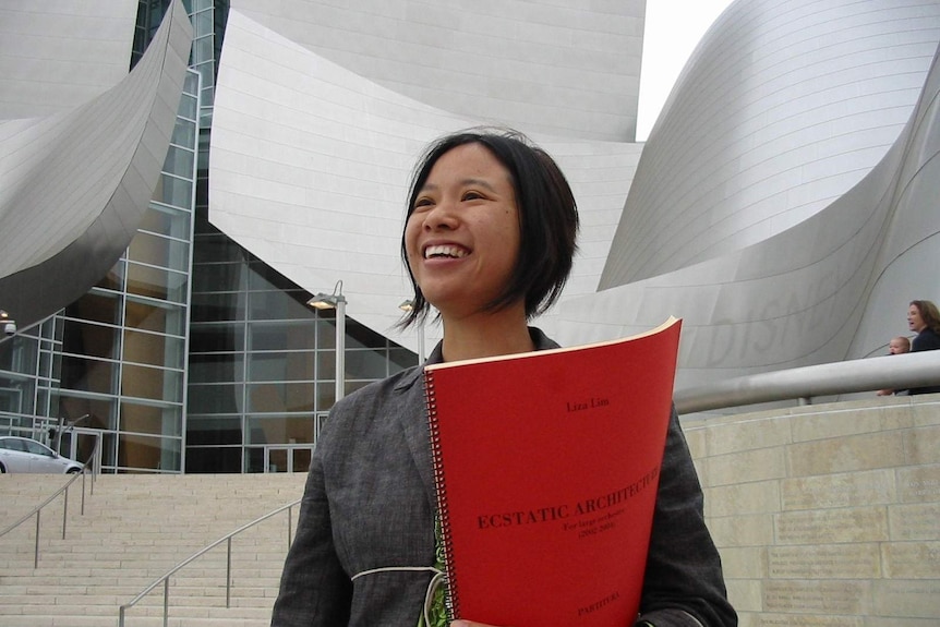 Liza Lim in front of the Disney Concert Hall with orchestral score commissioned for the opening. Photo by Michael Watson.
