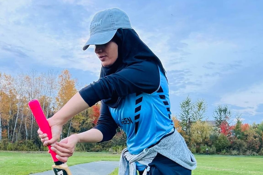 Roya Samim plays a shot with her bat.