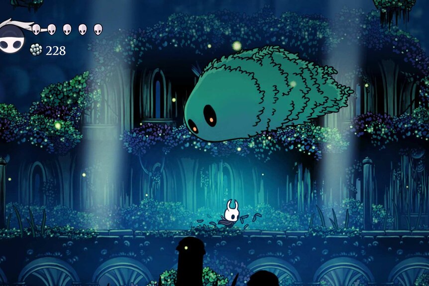 Still from the video game Hollow Knight featuring a blue hued forest with a strange creature and a little knight