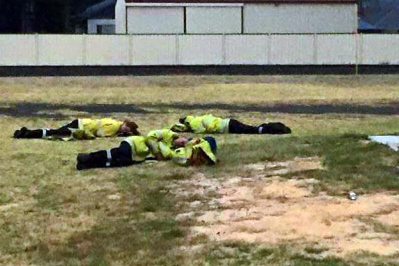 Exhausted fire fighters asleep on the grass