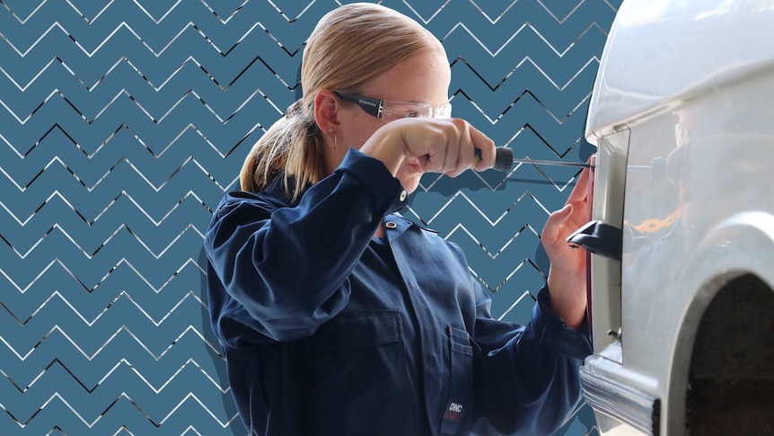 A girl uses a screwdriver on a car.