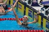 Regan Smith holds up her hand