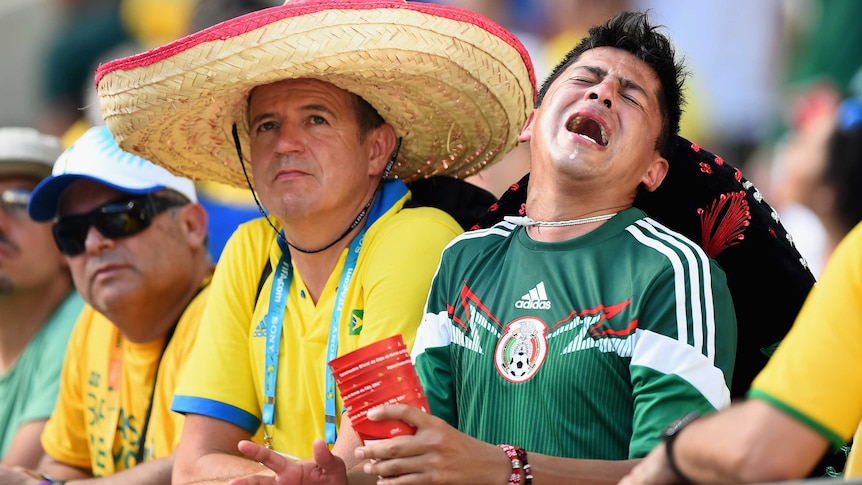 A Mexican fan shows his despair after his team loses to the Netherlands at the World Cup.