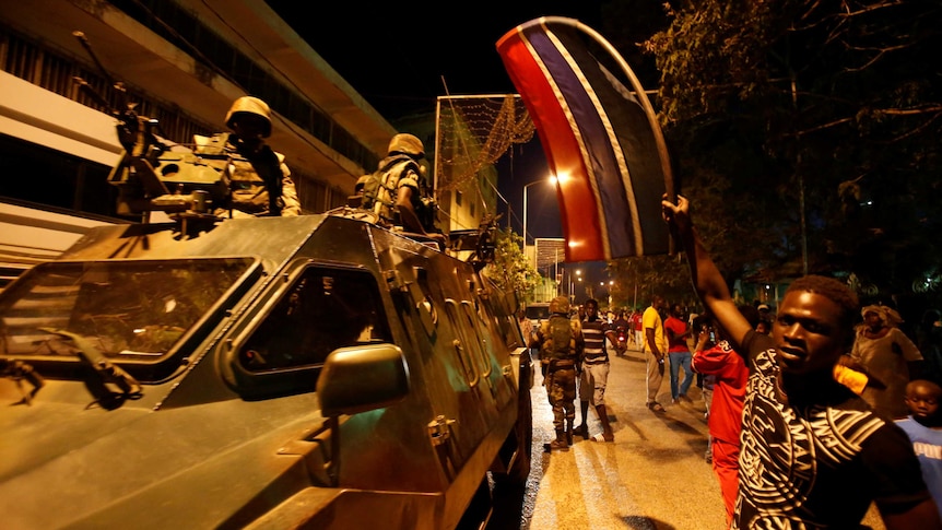 Members of the regional ECOWAS force are welcomed by people as they arrived in Banjul.