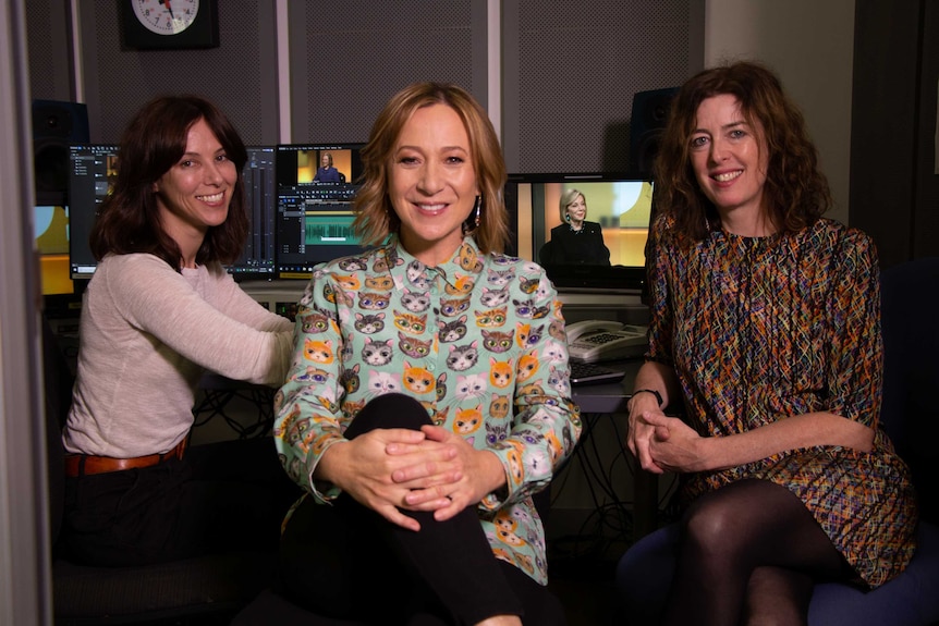 Three women sitting in edit suite.