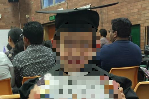 A boy holds a certificate