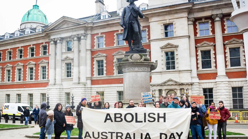 Protesters opposed to Australia Day gather at the statue of Captain James Cook in The Mall.