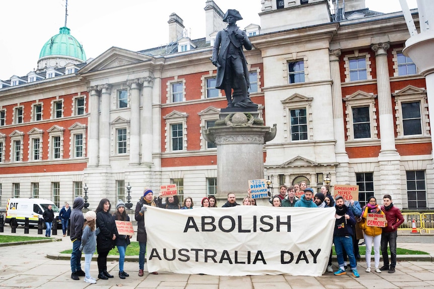 Protesters opposed to Australia Day gather at the statue of Captain James Cook in The Mall.
