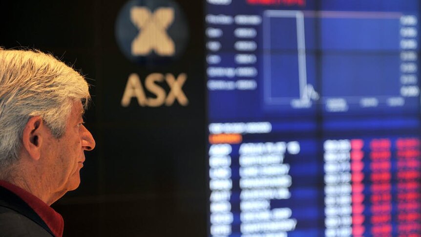 An investor looks at the ASX board in Sydney