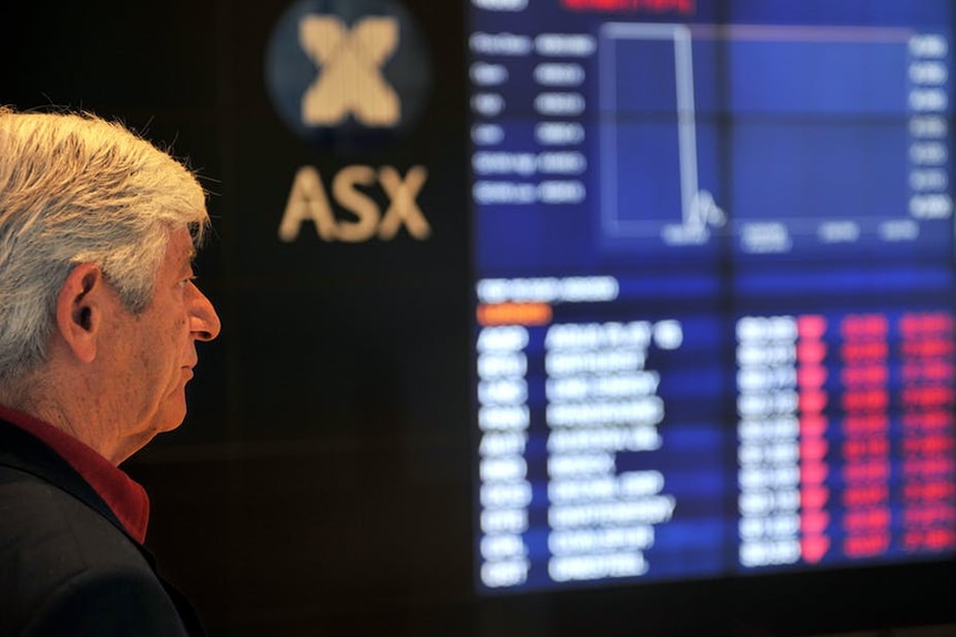 An investor looks at the ASX board in Sydney