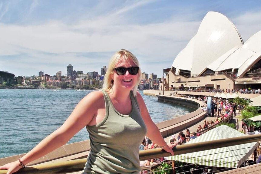 Frances Fairs stands in front of the Sydney Opera House.