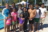 Four Australian swim teachers stand with eight Nepalese people from Albury who are learning to swim