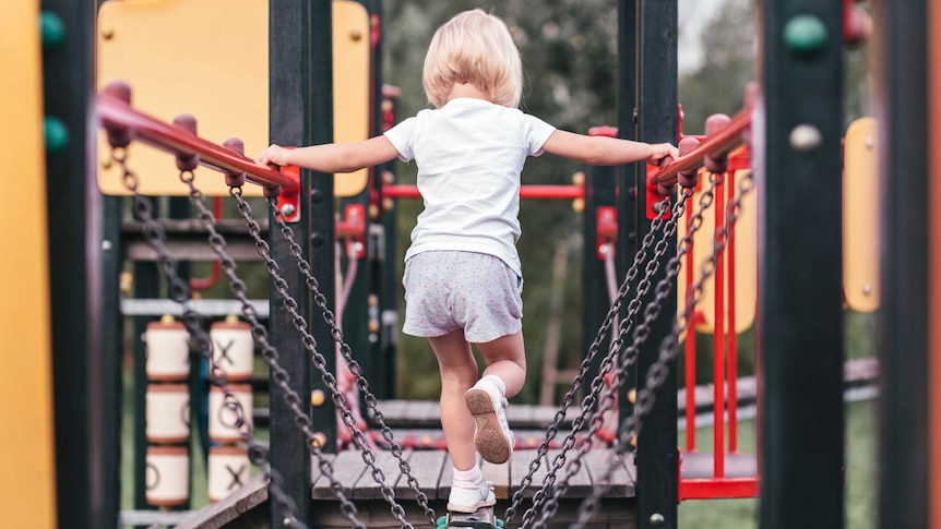 Child walking across a playground