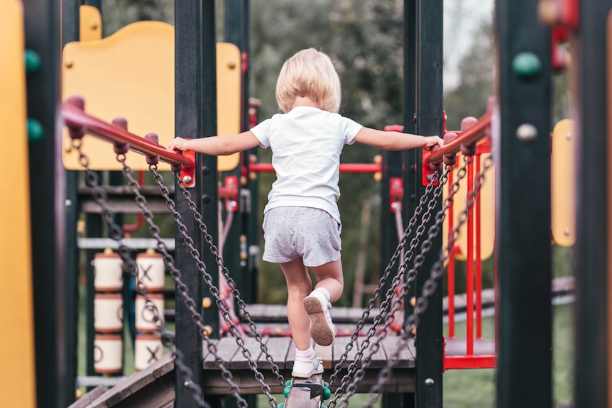 Child walking across a playground