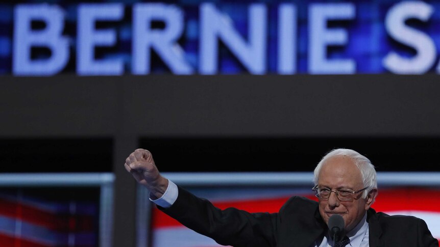 Former Democratic US presidential candidate Senator Bernie Sanders thrusts his fist